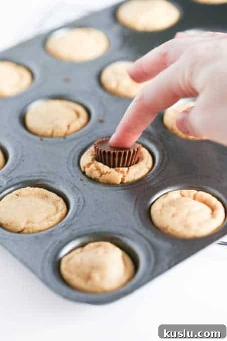 Reese’s Peanut Butter Cup Cookies Recipe: Gooey Chocolate Peanut Butter Treats 7 Pressing Reese's into cookies