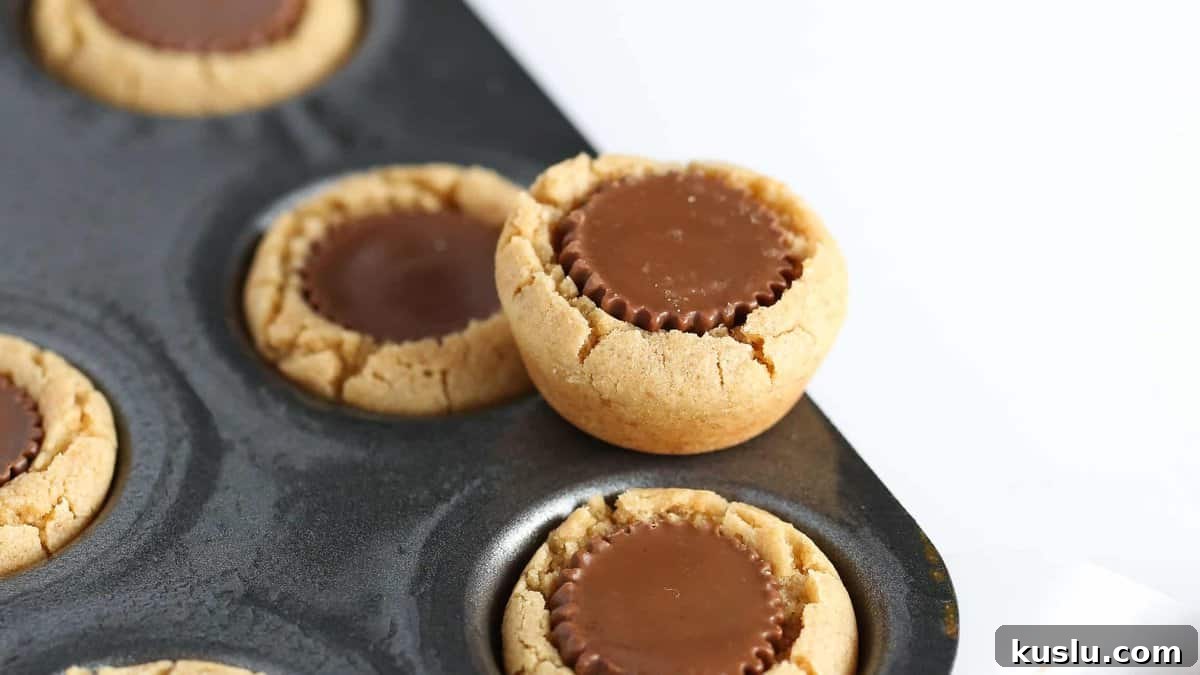 Reese’s Peanut Butter Cup Cookies Recipe: Gooey Chocolate Peanut Butter Treats 8 Finished cookies on a cooling rack
