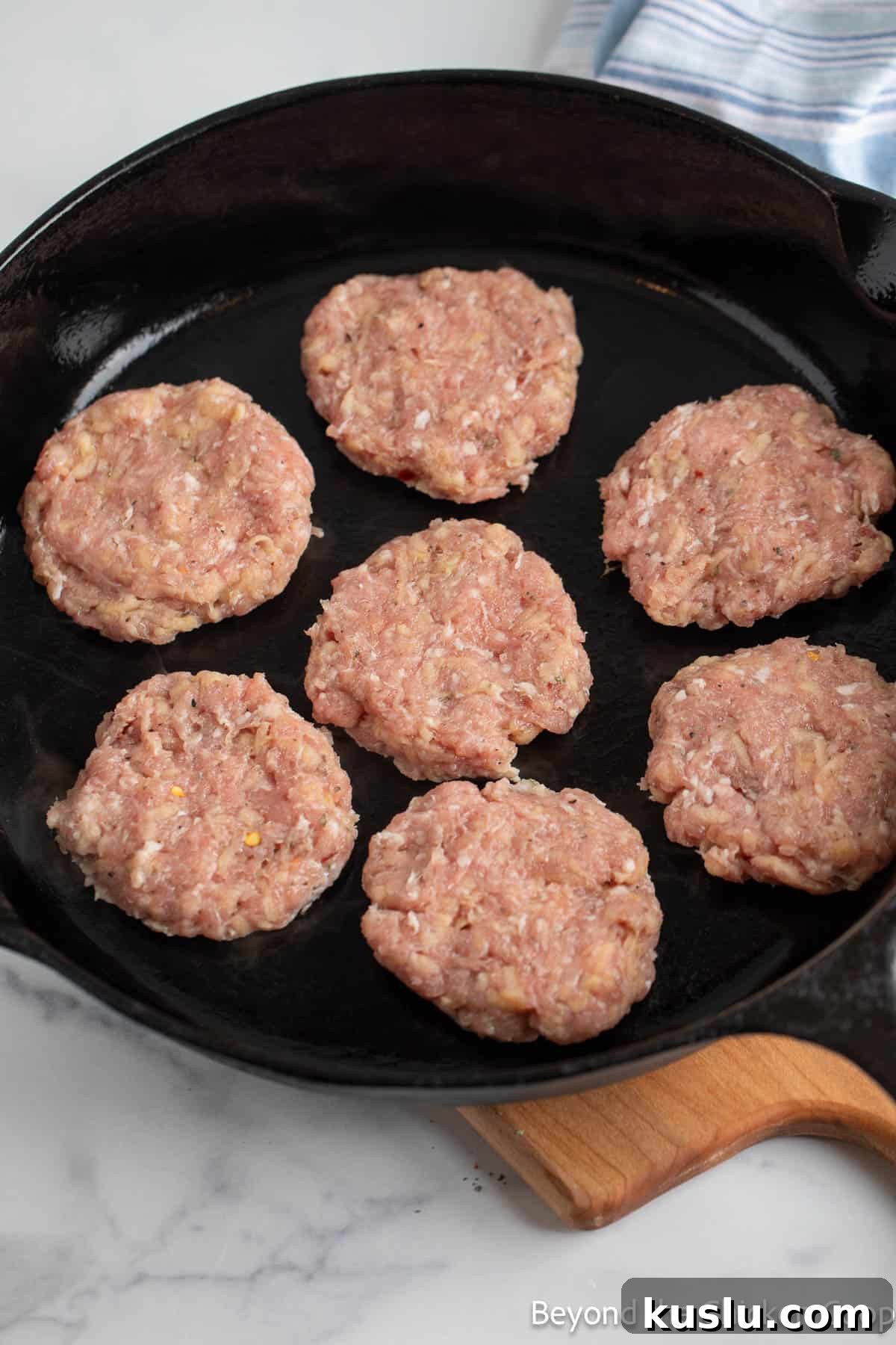 Sausage patties in a cast iron skillets.