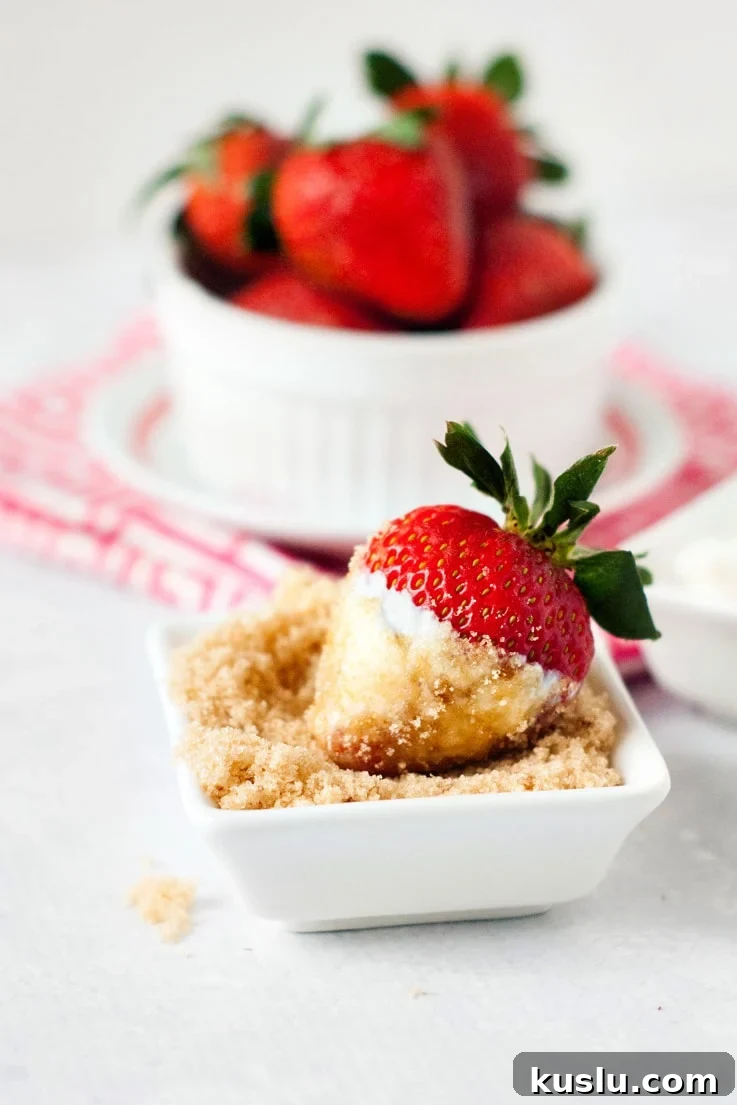 a fresh strawberry dipped in sour cream and brown sugar