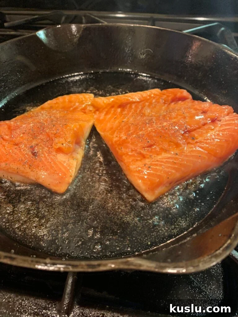 Salmon, skin side down in the skillet.