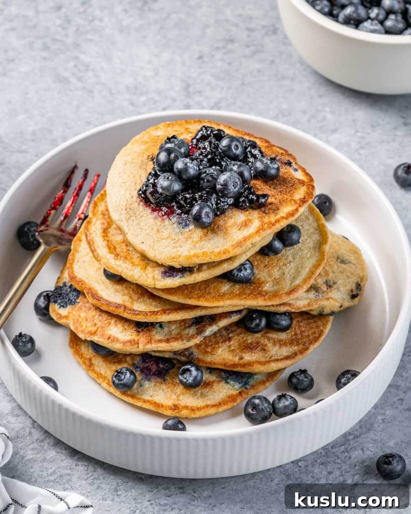 Lemon Blueberry Ricotta Pancakes Recipe for Fluffy, Tangy Stacks 8 blueberry pancake stacks on a plate