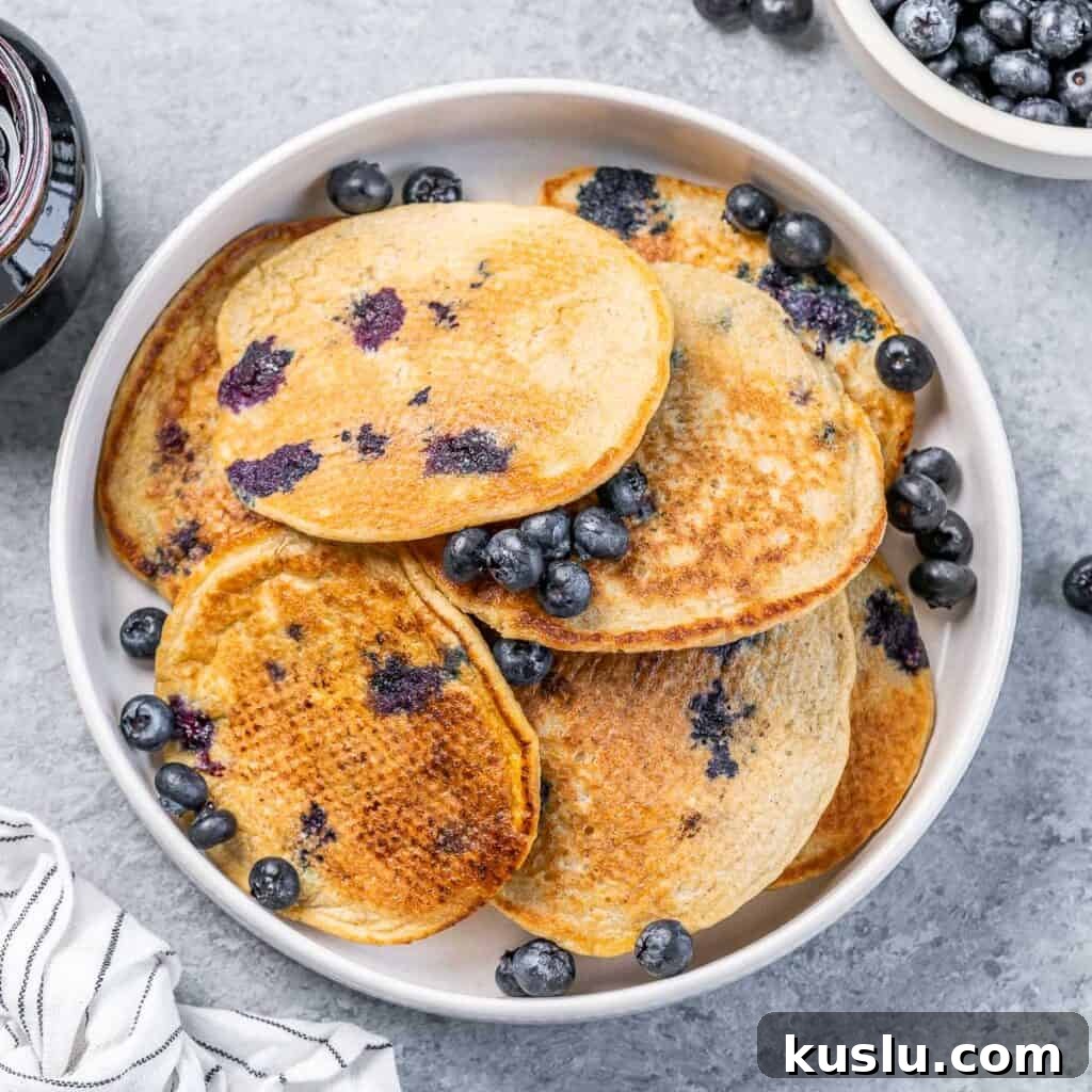 Lemon Blueberry Ricotta Pancakes Recipe for Fluffy, Tangy Stacks 10 top view of blueberry lemon ricotta pancakes on a round white plate