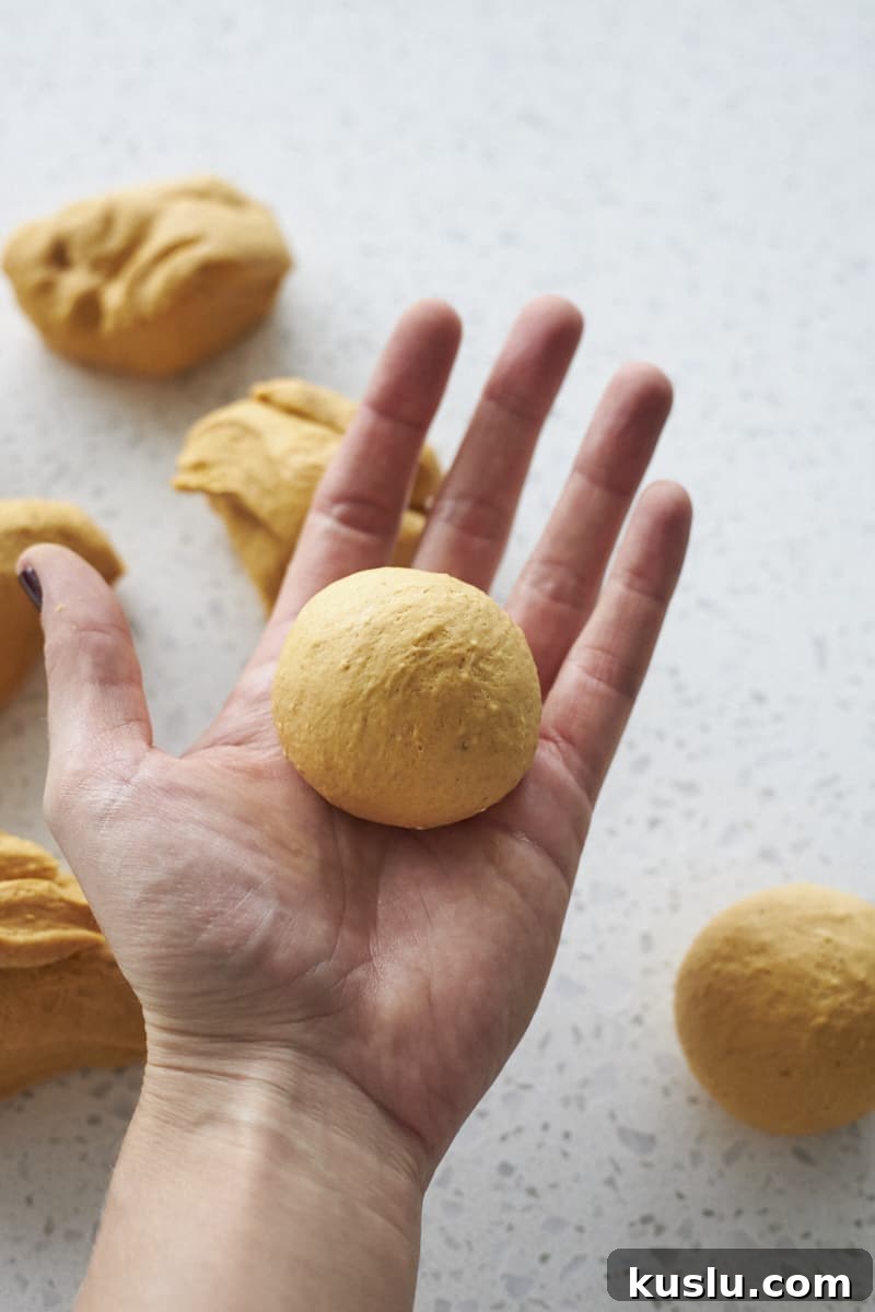 Dinner rolls shaped in the palm of a hand.