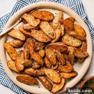 halved fingerling potatoes on plate with fork on the side