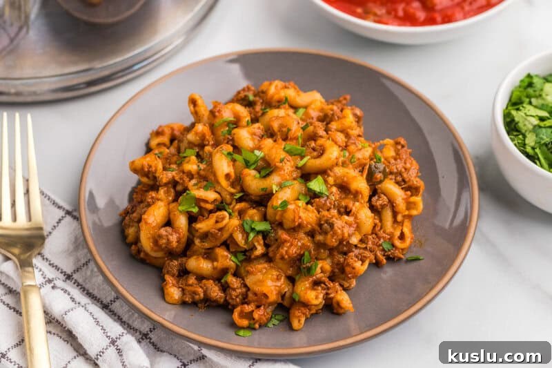 Simple Weeknight Dinner Recipes for Busy Families 13 One Pan Taco Pasta served on a grey plate.