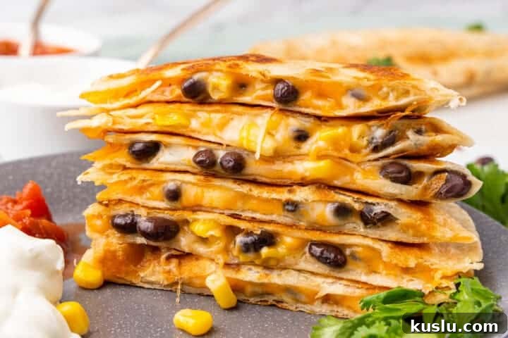 Simple Weeknight Dinner Recipes for Busy Families 21 Black Bean Quesadillas stacked on a plate.