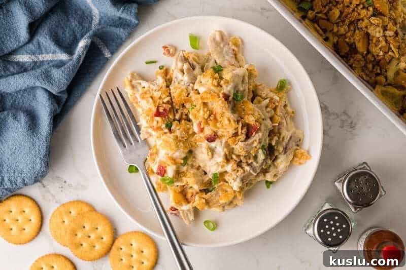 Simple Weeknight Dinner Recipes for Busy Families 4 Million Dollar Chicken Casserole served on a white plate.