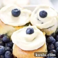 1-Hour Gluten Free Blueberry Sweet Rolls - perfect for brunch! Recipe from @whattheforkblog | whattheforkfoodblog.com | Sponsored by Bonne Maman | gluten free baking | easy gluten free recipes | gluten free bread recipes | yeast rolls | brunch recipes | sweet roll recipes | homemade dough recipes |