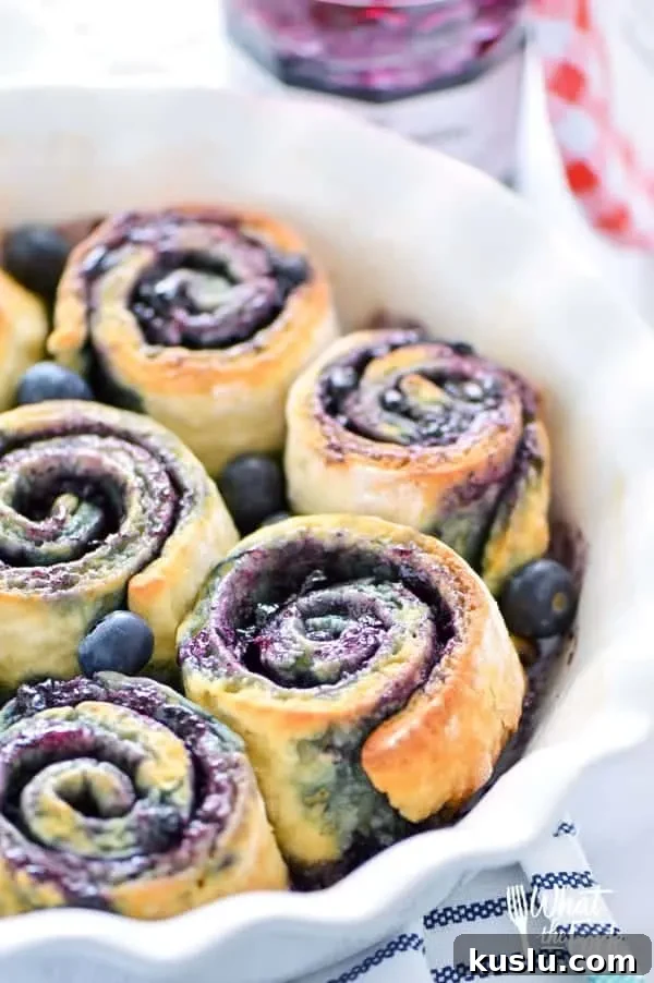 1-Hour Gluten Free Blueberry Sweet Rolls - perfect for brunch! Recipe from @whattheforkblog | whattheforkfoodblog.com | Sponsored by Bonne Maman | gluten free baking | easy gluten free recipes | gluten free bread recipes | yeast rolls | brunch recipes | sweet roll recipes | homemade dough recipes |