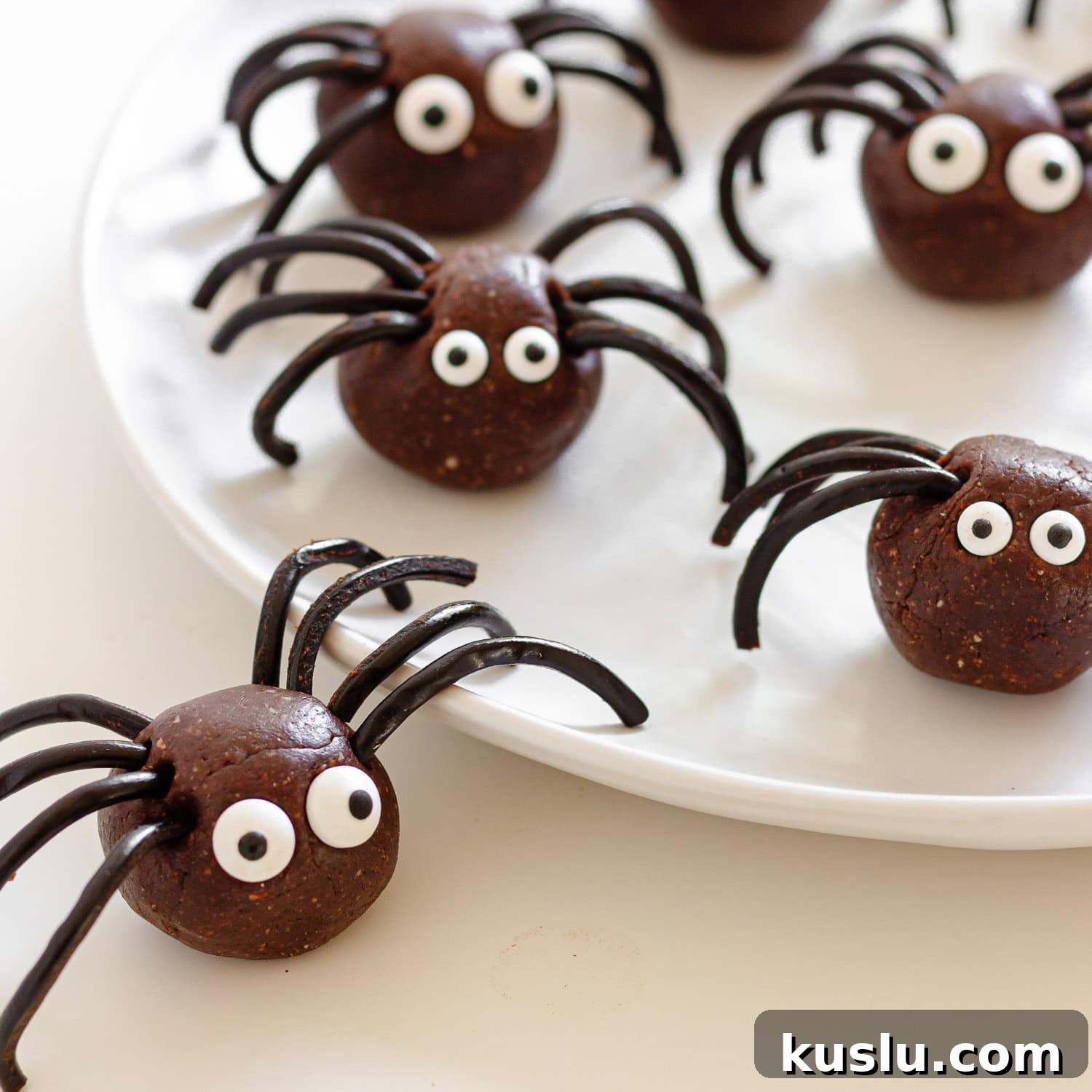 Spider energy bites on a white plate.