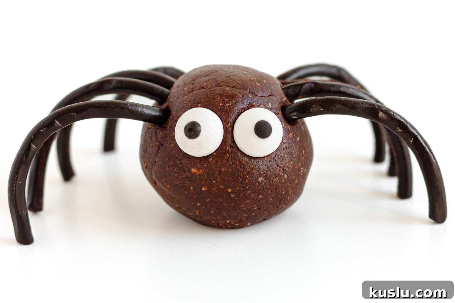Closeup of a spider energy ball on a white surface.