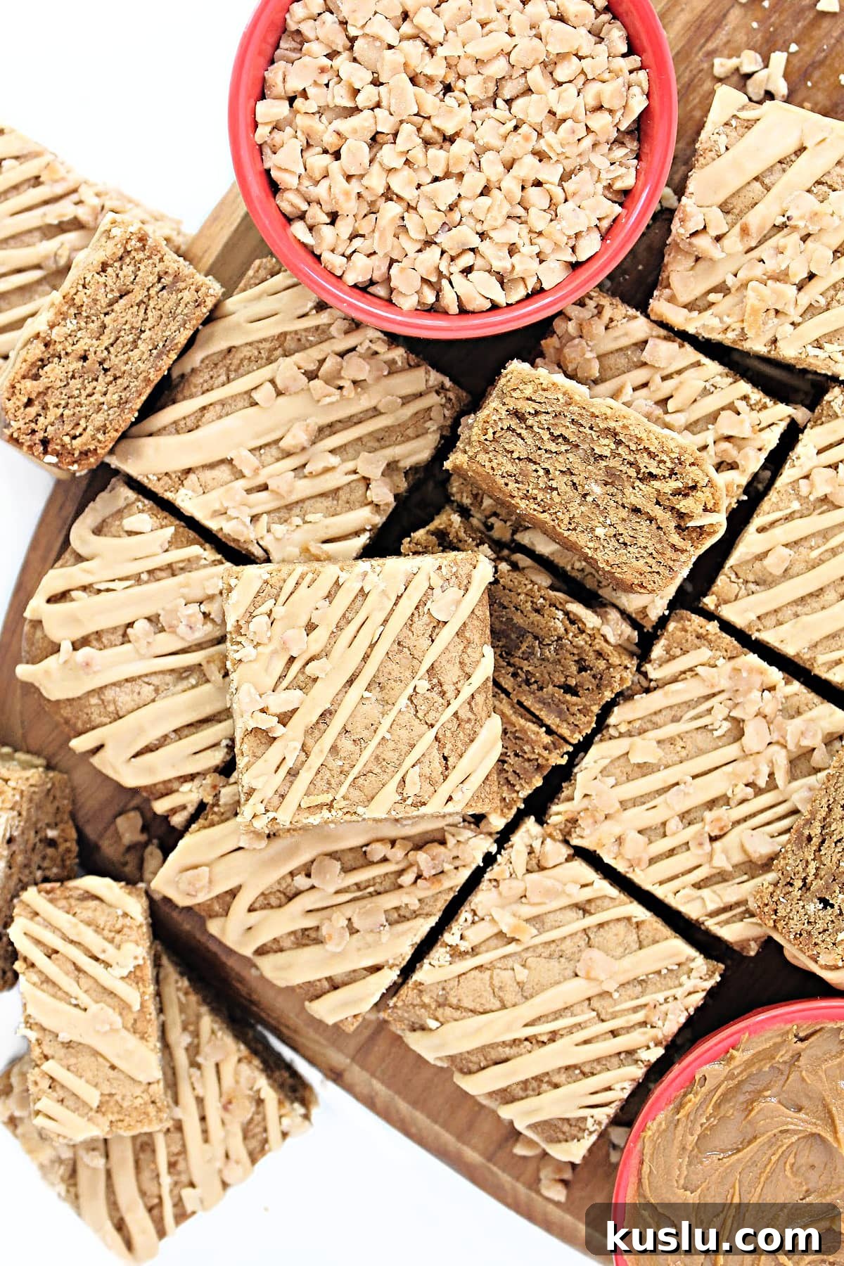 Biscoff Blondie Bars: Chewy Lotus Biscoff Cookie Dessert 2 Squares of Biscoff Blondies drizzled with Biscoff icing and sprinkled with toffee bits.