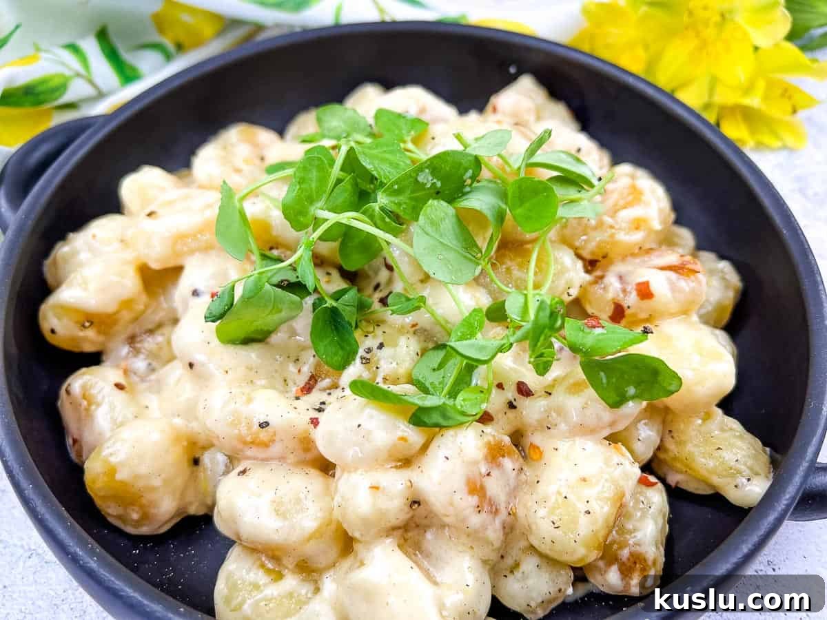 17 Tangy Lemon Recipes Made for Flavor, Not Fancy Presentation 15 Gnocchi in Lemon-Parmesan Sauce on a black plate.