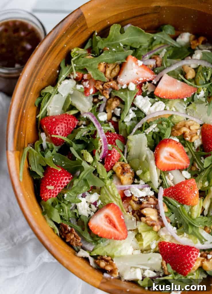 Mediterranean Tuna Pasta Salad with Olives and Cherry Tomatoes 7 Strawberry and walnut salad with leafy greens and feta in a wooden bowl.