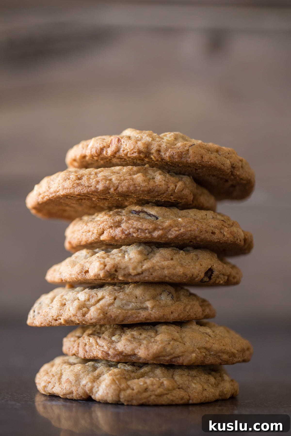 Seven Bakery Style Oatmeal Raisin Cookies stacked on top of each other. 
