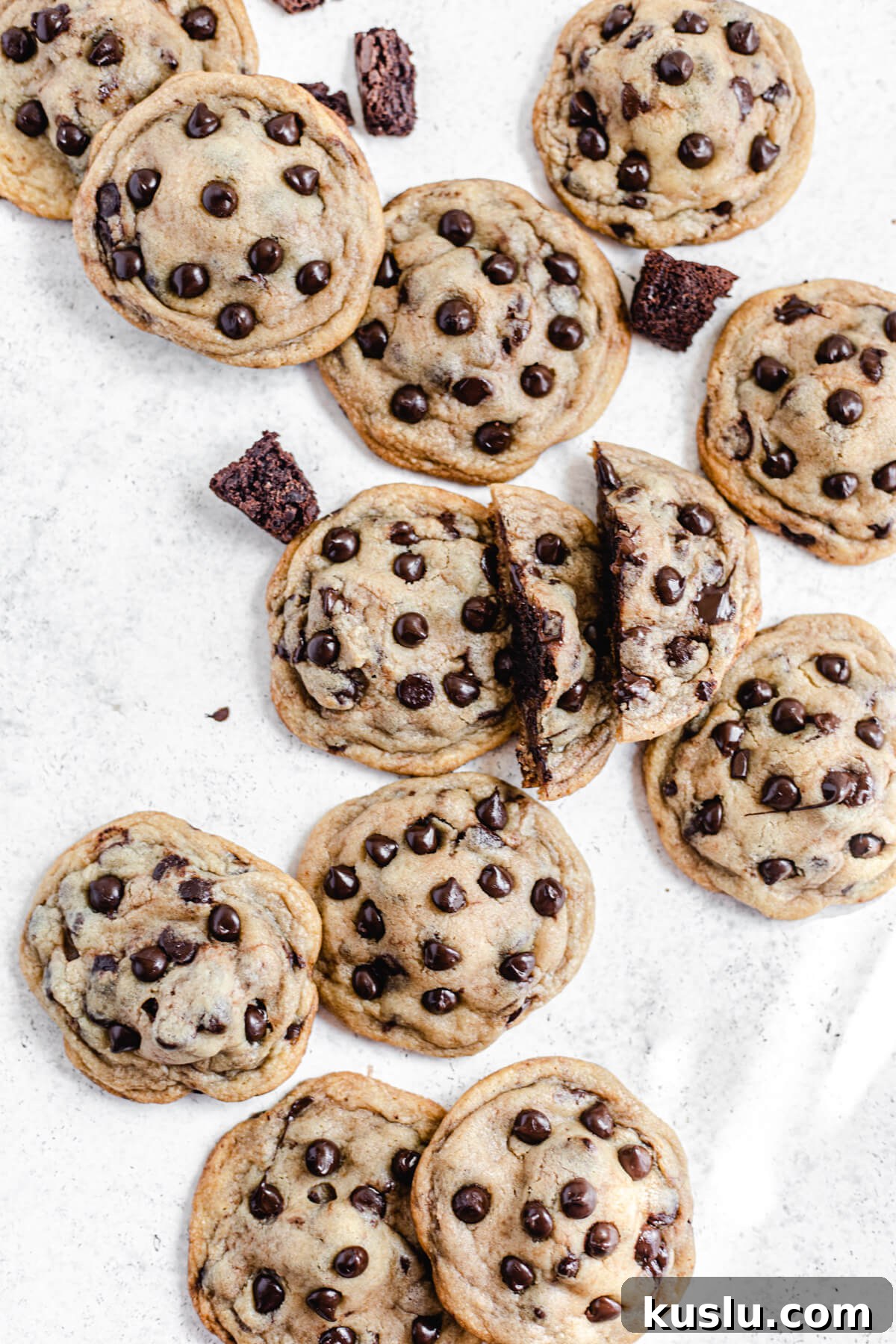 chocolate chip cookies and brownie chunks with one cookie broken in half