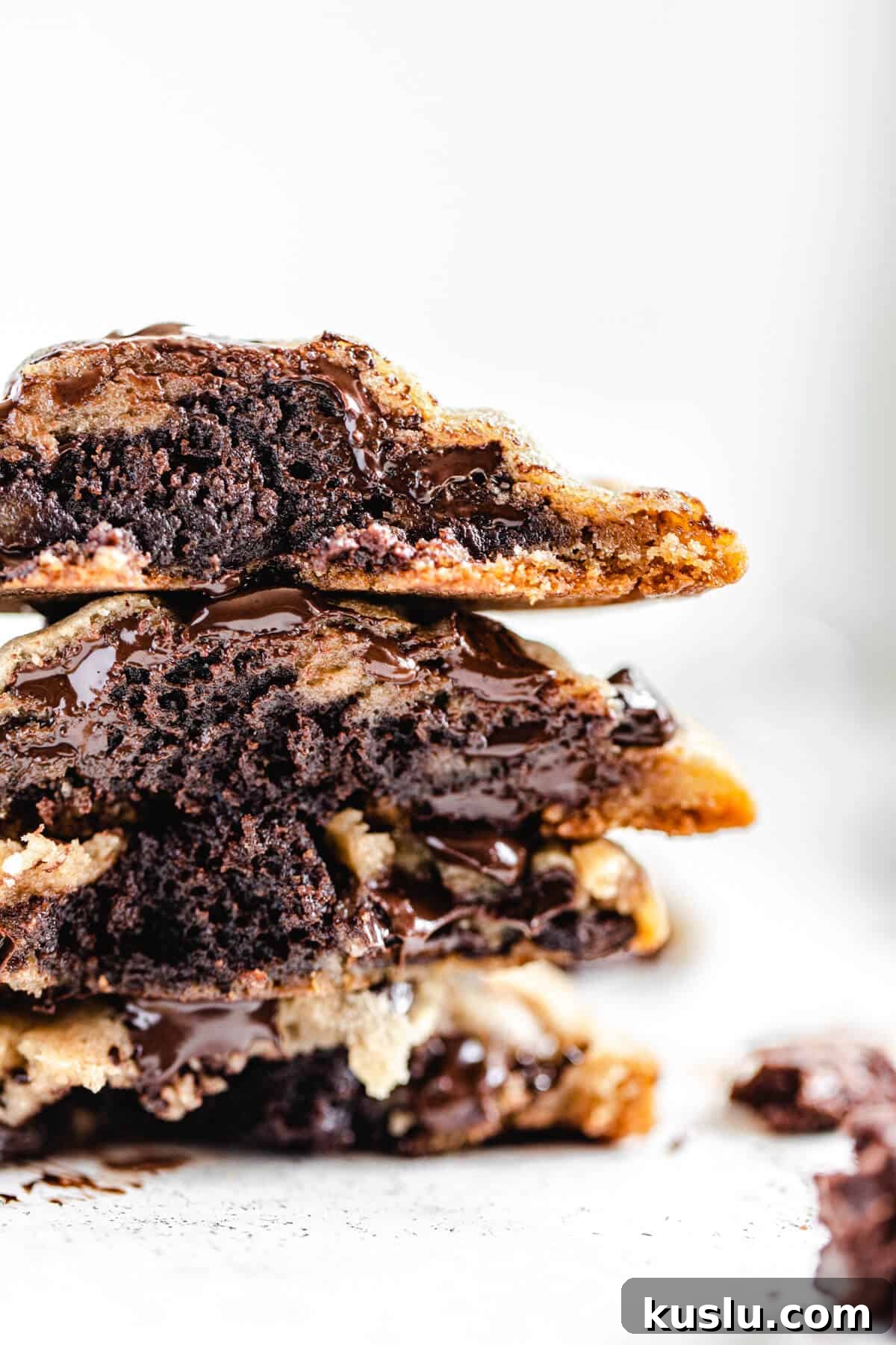 stack of halved brownie stuffed chocolate chip cookies