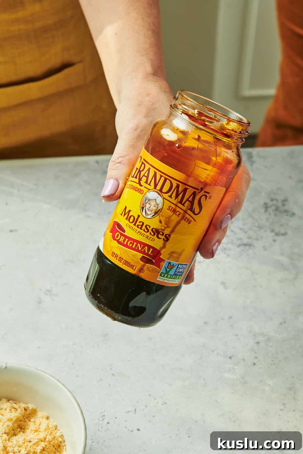 Brown Sugar Substitute: Simple Homemade Alternatives and Tips 2 Woman holding jar of molasses.