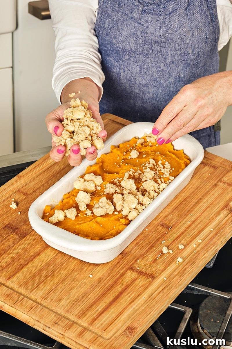 Brown Sugar Substitute: Simple Homemade Alternatives and Tips 5 Adding topping to Butternut Squash Casserole in pan.
