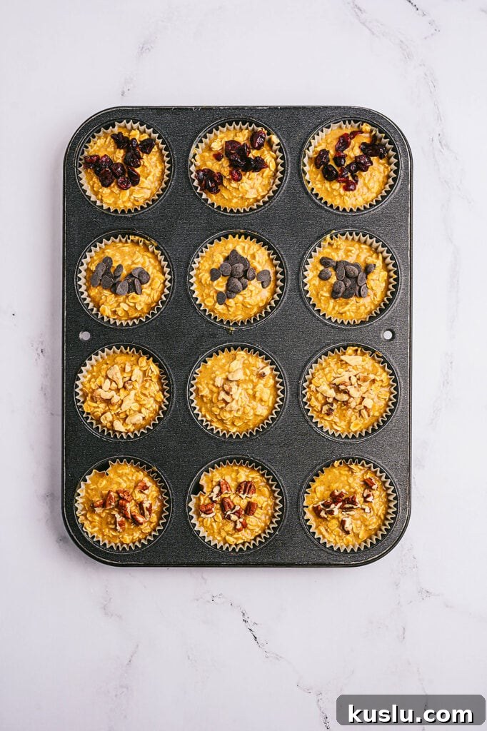Overhead image: pumpkin oatmeal muffins with toppings, in a muffin tin