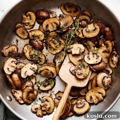 Sauteed mushrooms with thyme in a pan.