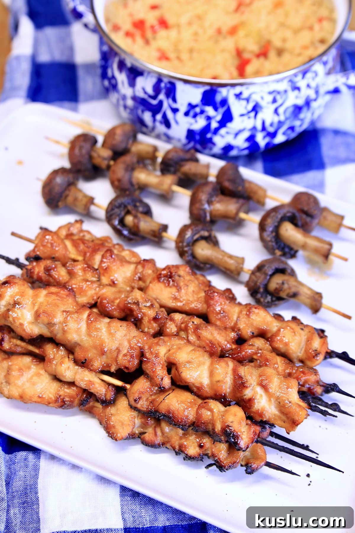 Chicken Teriyaki Skewers with mushrooms on a platter.