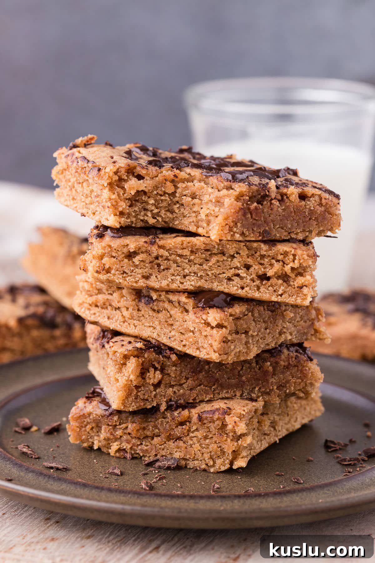 Chewy Peanut Butter Cookie Bars Recipe for Crowd-Pleasing Treats 2 Stack of cookie bars on a dark plate.