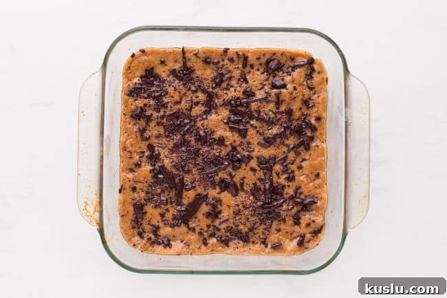 Chewy Peanut Butter Cookie Bars Recipe for Crowd-Pleasing Treats 7 Unbaked cookie dough topped with chocolate chips.