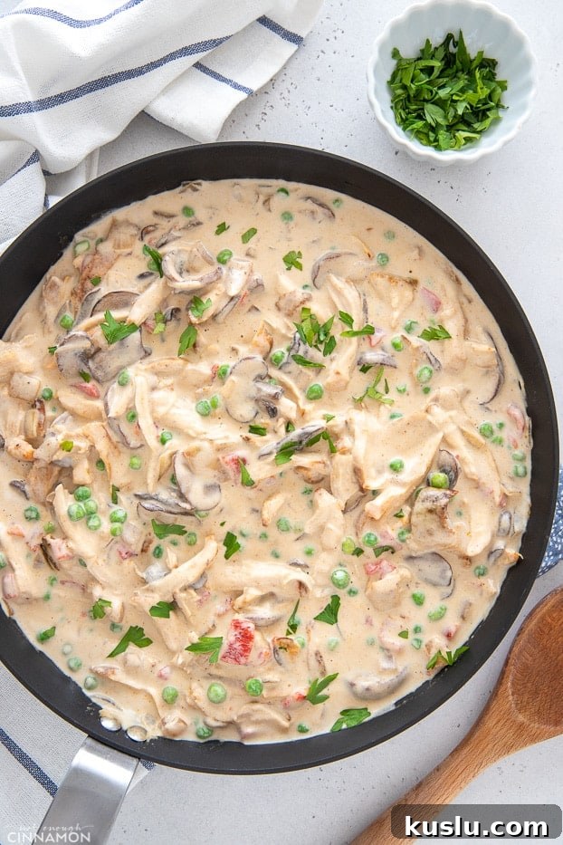 overhead shot of a skillet with creamy chicken a la king 