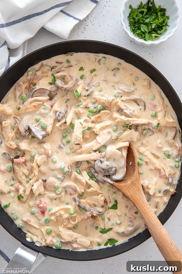 a black skillet with creamy dairyfree chicken a la king with a wooden spoon 