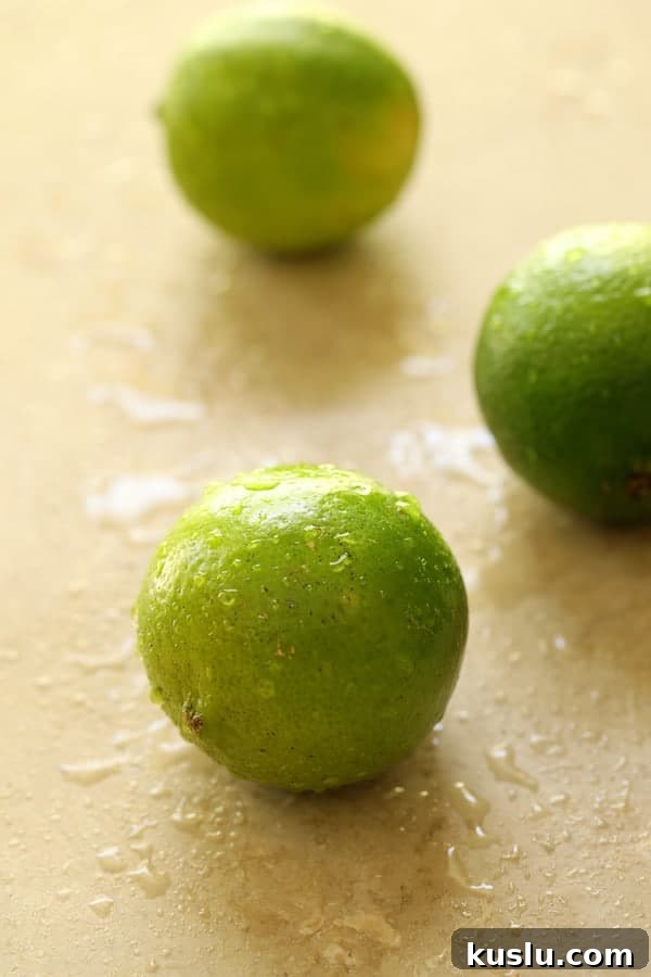 Photo of three freshly washed limes.