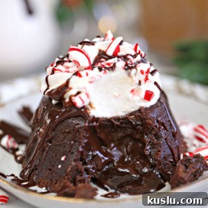 Close-up of Peppermint Lava Cake with whipped cream, chocolate drizzle, and candy cane pieces on top.