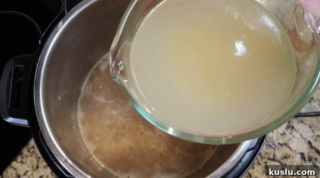 Adding broth to pot