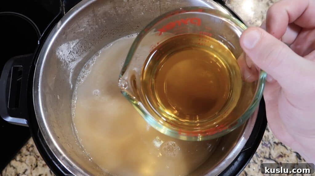 Adding apple juice to pot