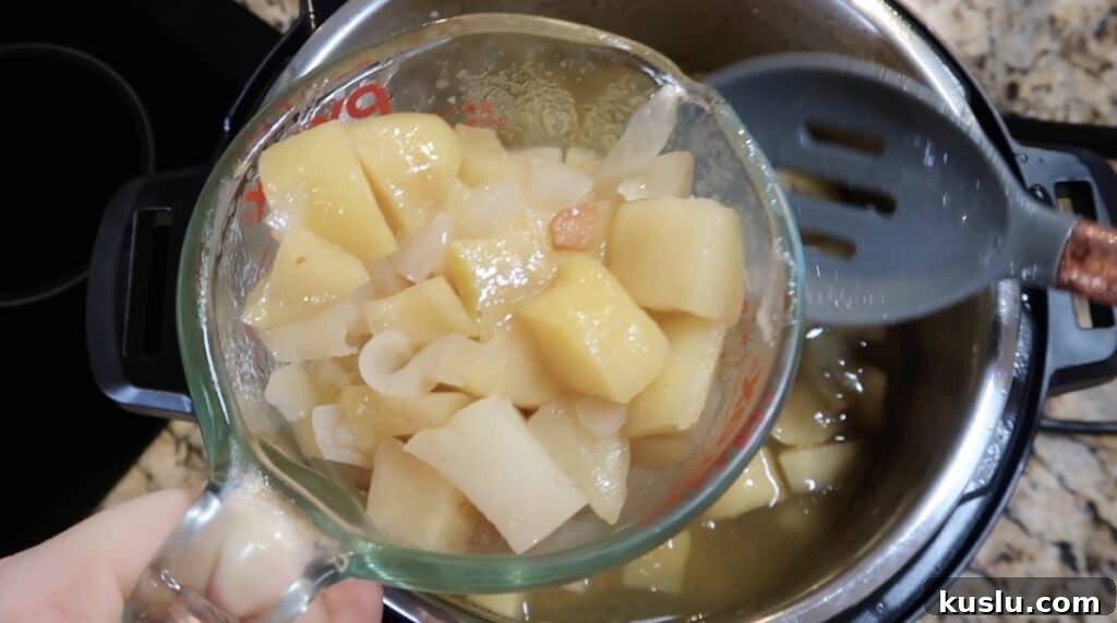 Removing some potatoes and apples with a slotted spoon