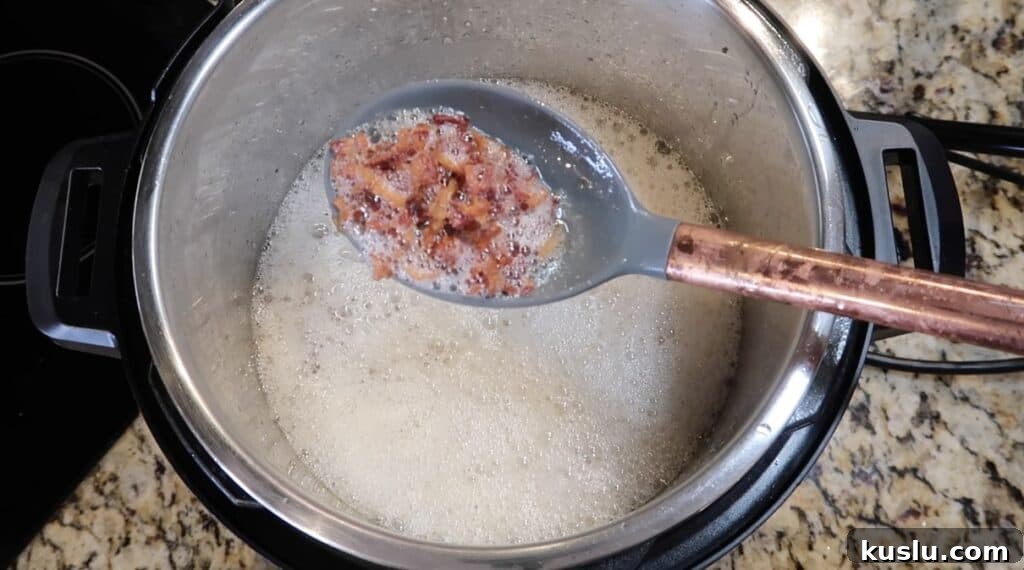 Using slotted spoon to remove cooked bacon from pot