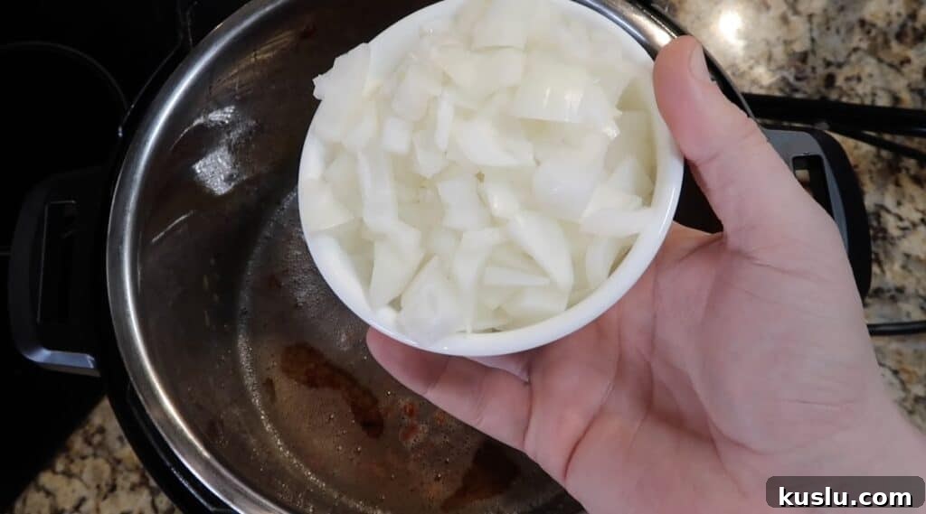 Adding diced onion to pot