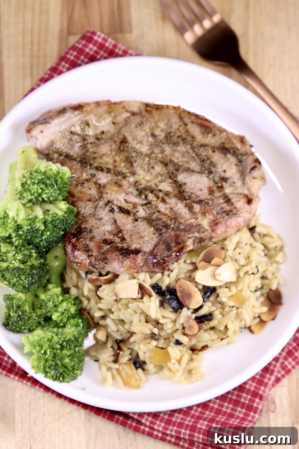 Plate with rice pilaf, broccoli and grilled pork chop
