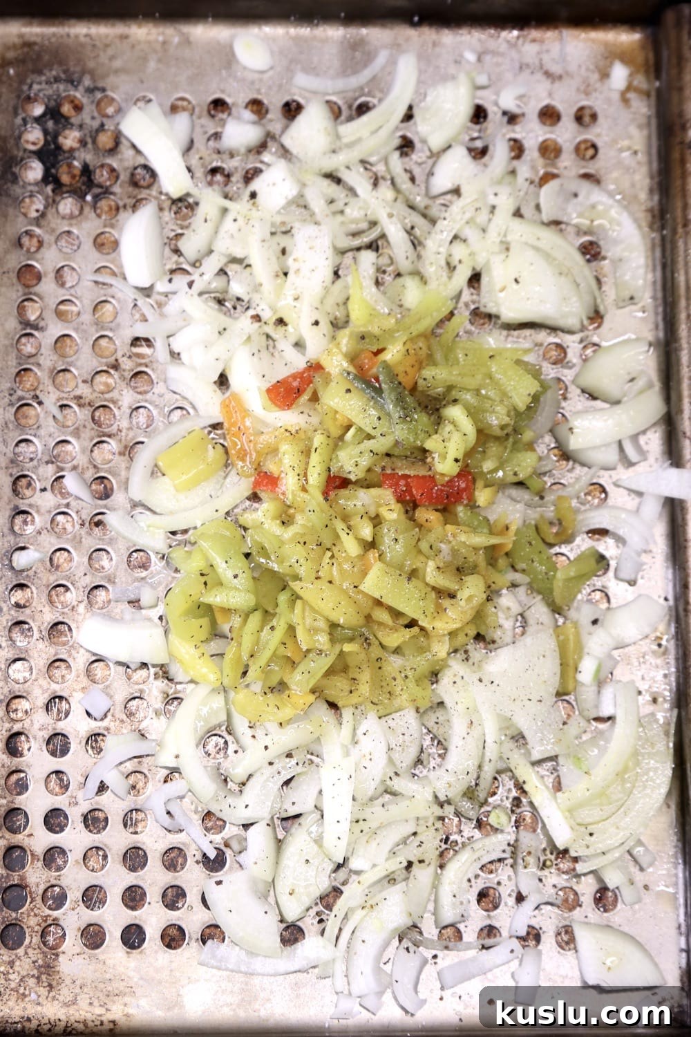 grill pan with sliced onions and peppers