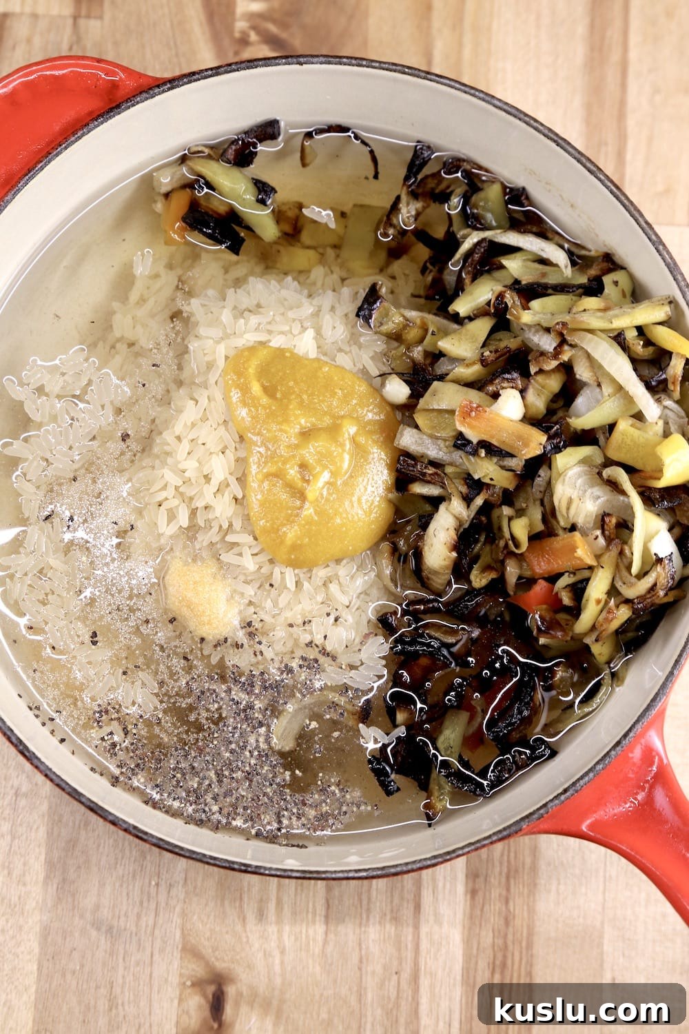 pan with water, rice, vegetables, chicken base