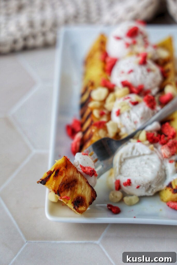 A grilled pineapple split with ice cream on top.