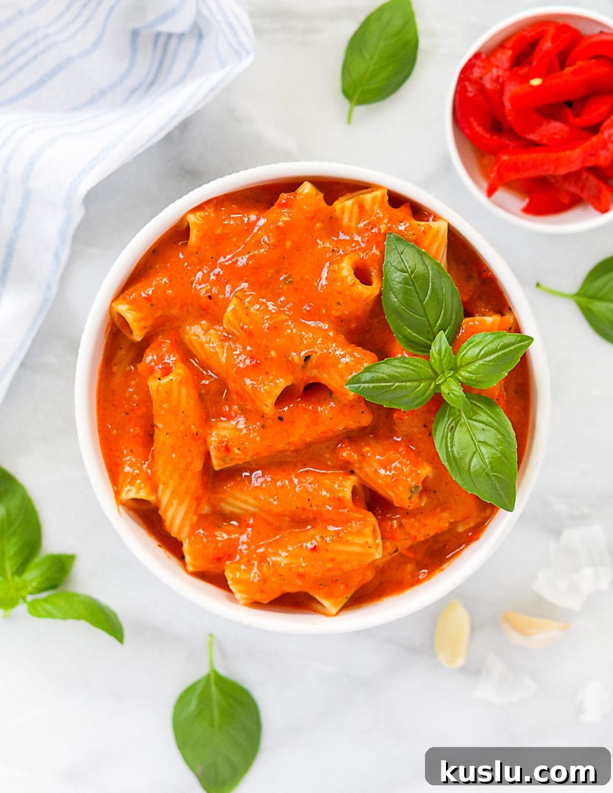A white bowl filled with red pepper pasta sauce