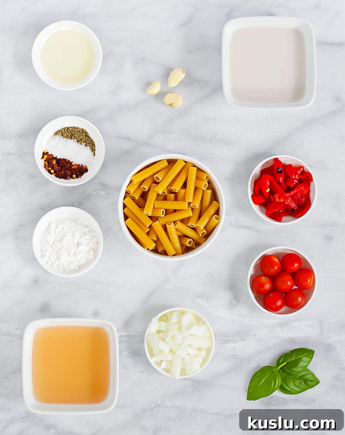 Ingredients for pepper pasta including noodles, plant based milk, spices, roasted red pepper, tomatoes, basil, onion, garlic, broth