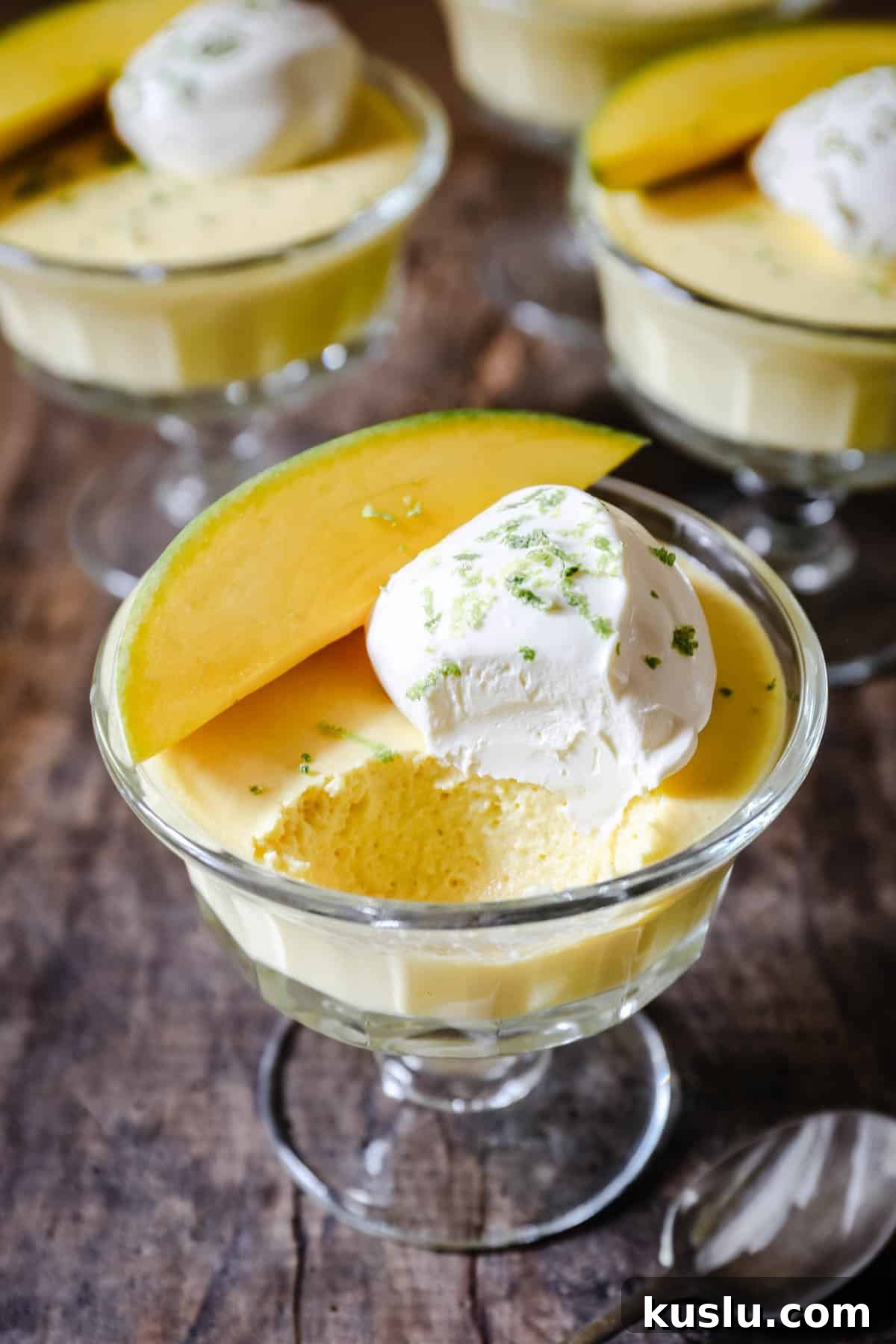A bowl of mango pudding with spoon ful taken out