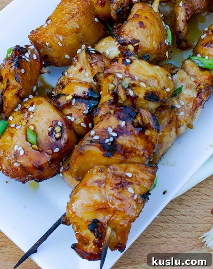 three Grilled Asian Chicken Kabobs on a white platter