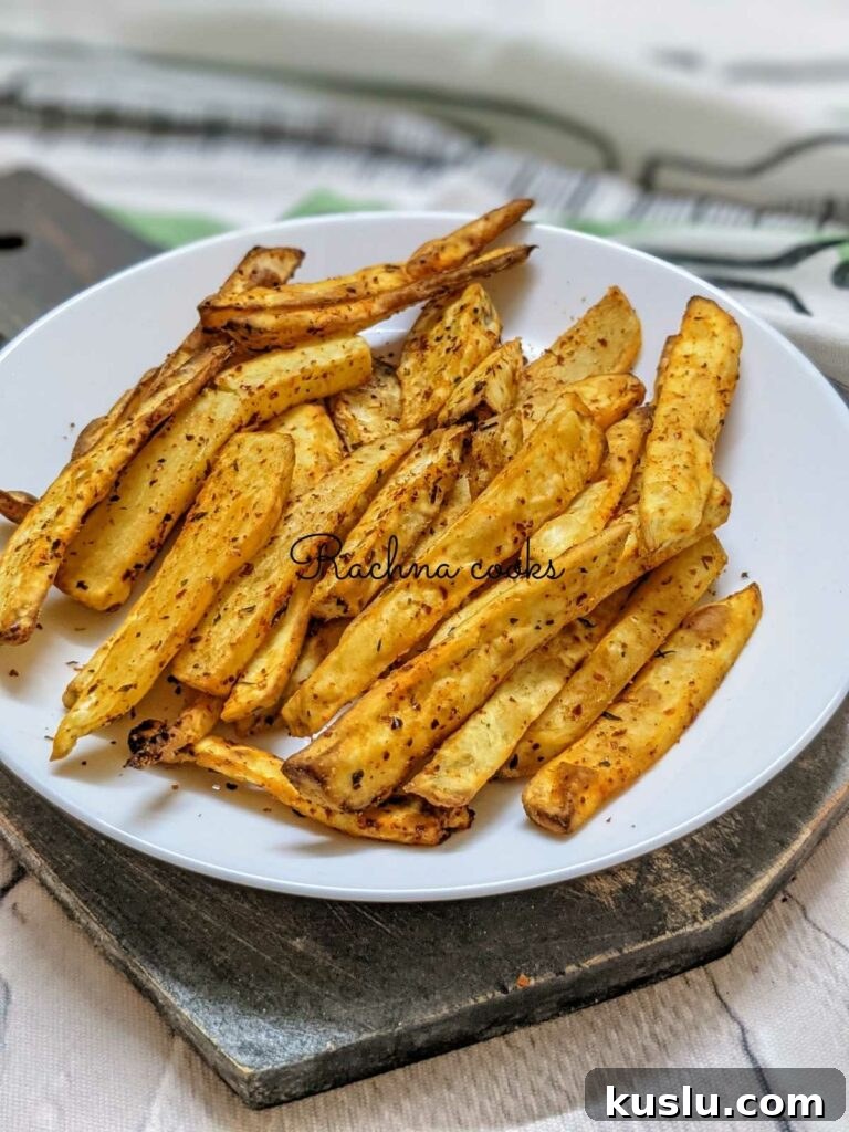 Crispy air fryer sweet potato fries on a white plate.
