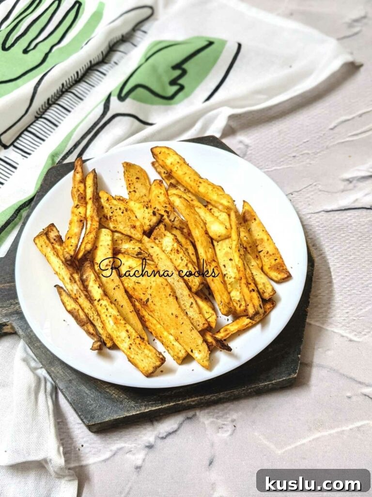 Crispy air fryer sweet potato fries on a white plate.