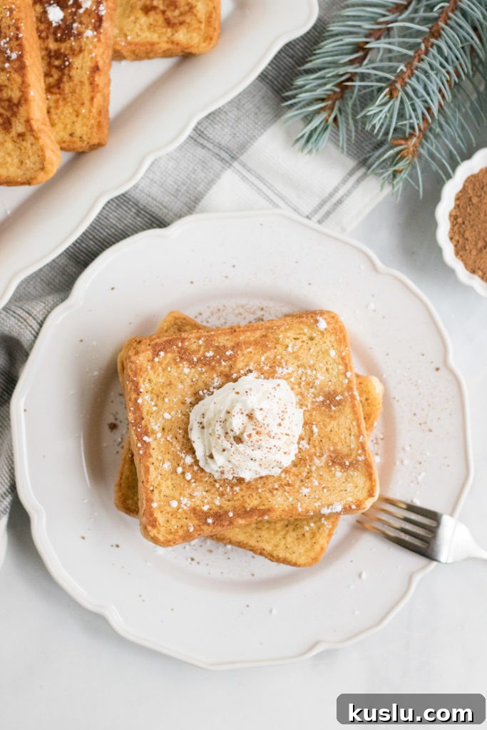 Overhead image of egg nog french toast on a plate with whipped cream